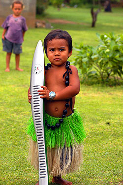David. Dressed in traditional attire, David, 3 is one of the 1800 people on the island who had the honour of holding the revolutionary Queen's Baton.